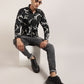 A man wearing a black abstract printed shirt by Monsui