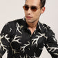 A man showing off the black abstract printed shirt by Monsui