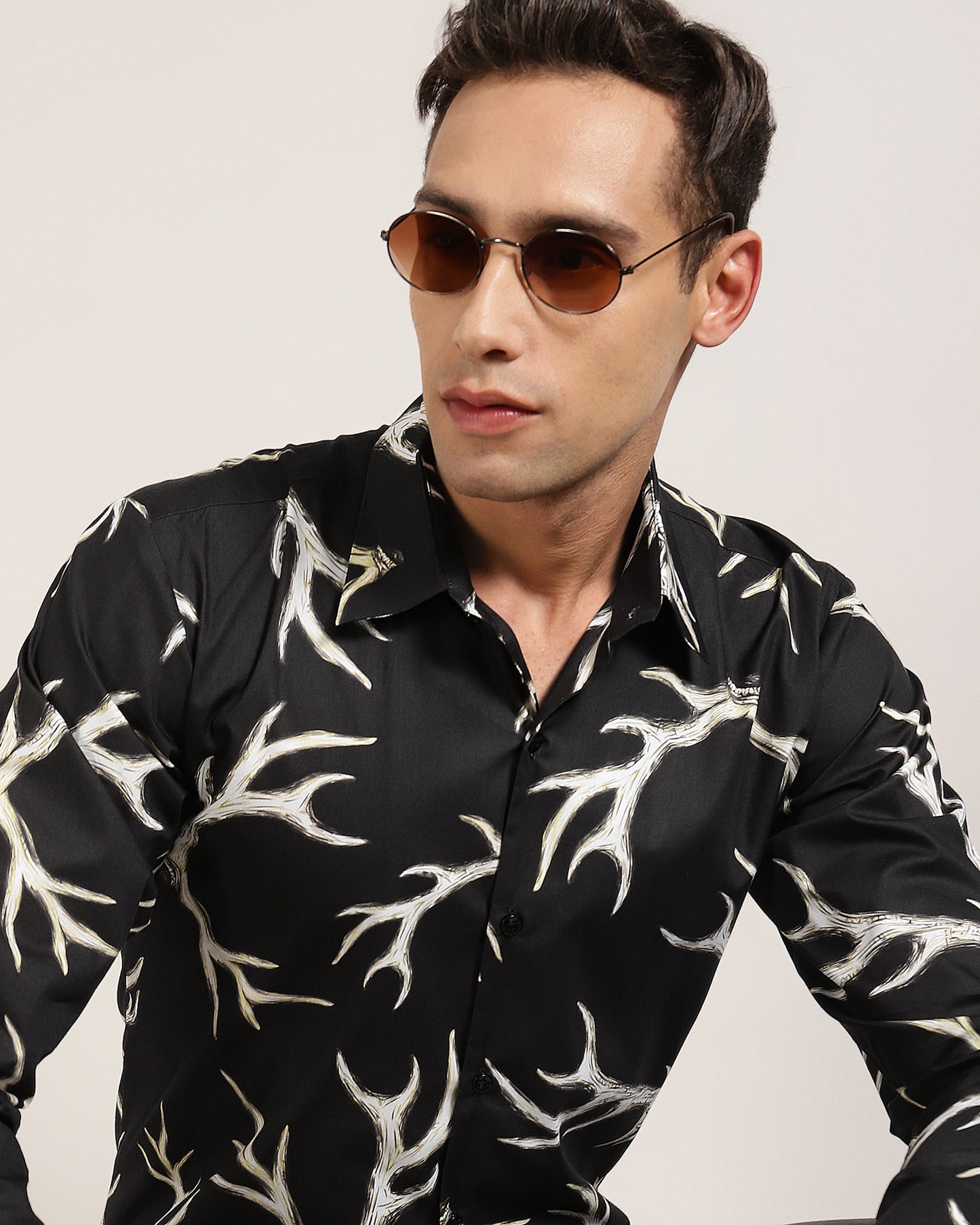 A man showing off the black abstract printed shirt by Monsui