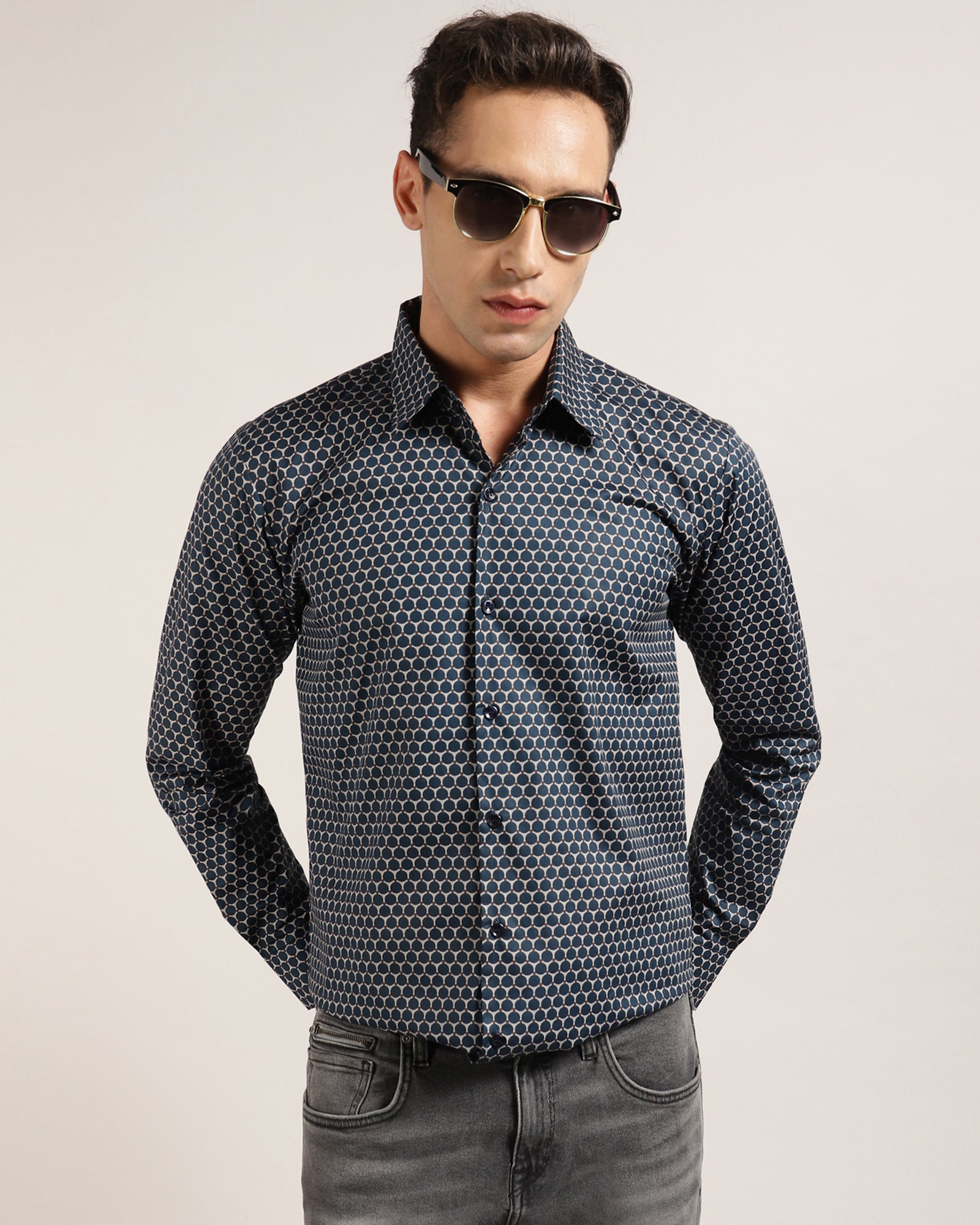 A man wearing a stylish geometric printed shirt by Monsui