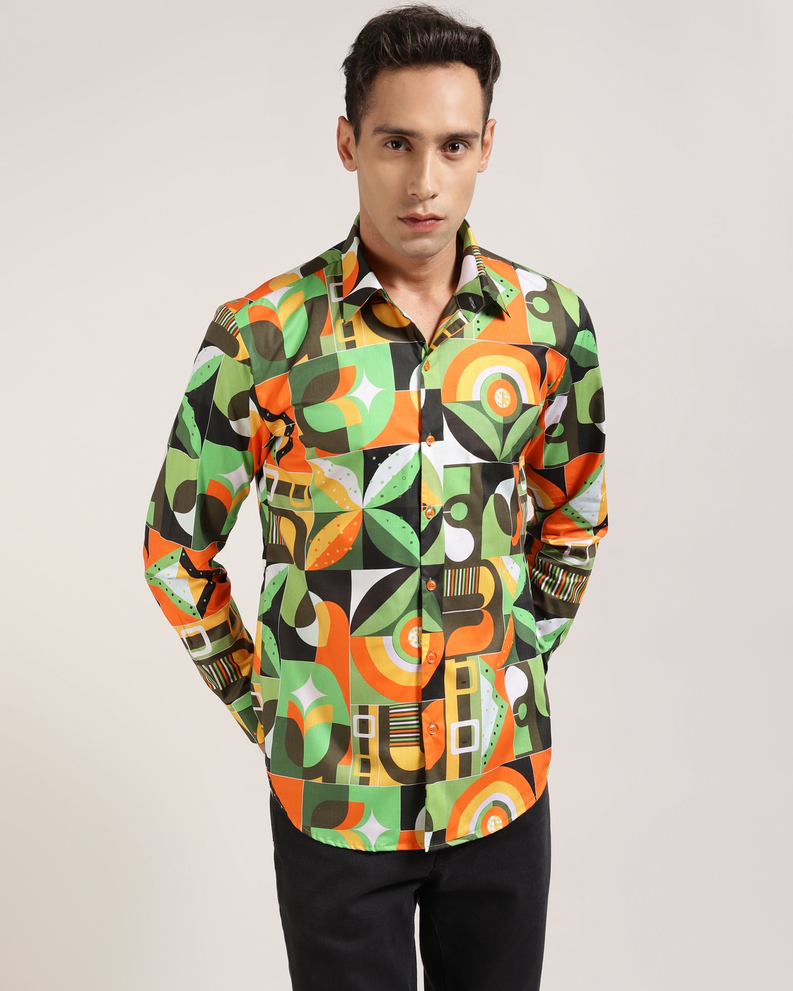 A shirt folded to show the green abstract geometric print.