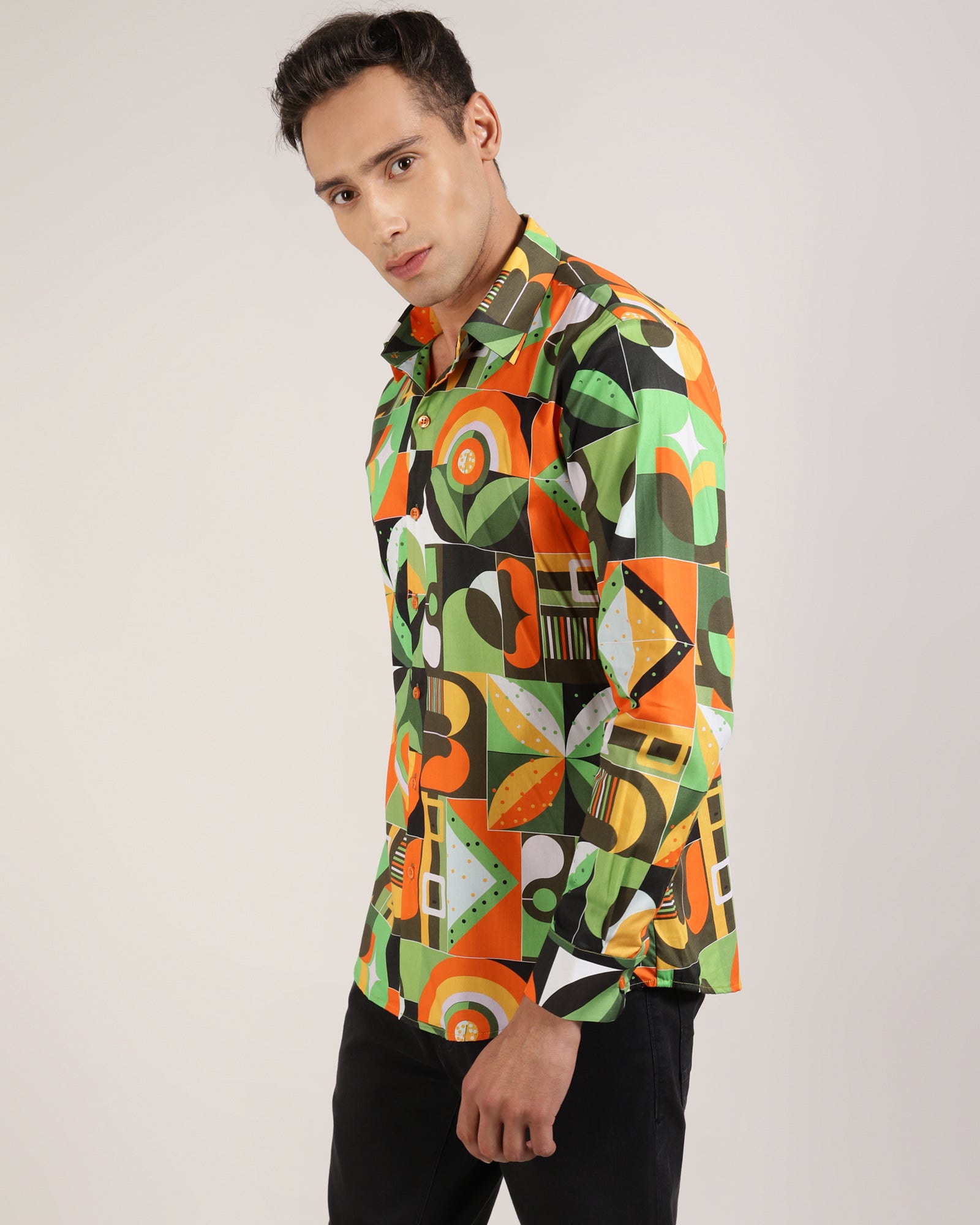 A close-up of the green abstract geometric print on a shirt.