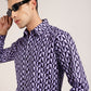 Make a bold statement with the purple and black geometric print shirt by Monsui